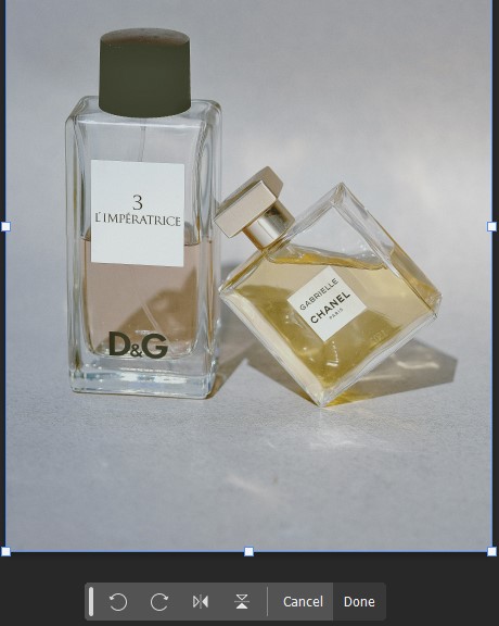 A stylish perfume bottle alongside a smaller bottle of perfume, showcasing Deselecting Transform Tool in Photoshop.
