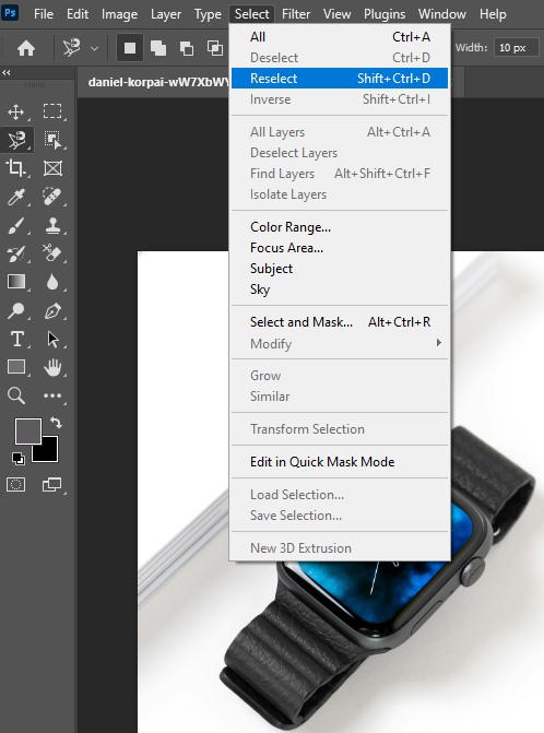 An Apple Watch displayed within the Adobe Photoshop interface, showcasing the reselect object feature in action.