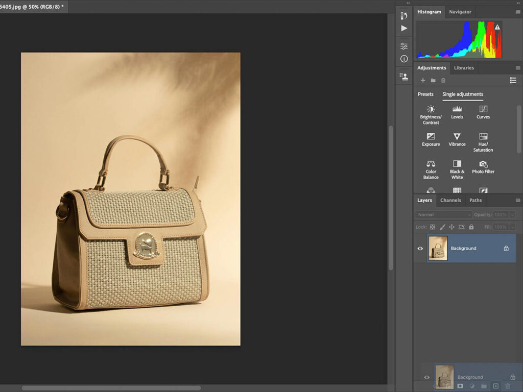 Image of Adobe Photoshop interface showing a photo being edited with layers and the background duplication process.