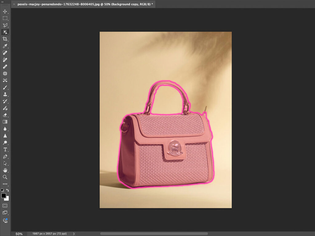 A pink purse displayed in Adobe Photoshop, with a pink overlay appearing when the mouse hovers over the image.