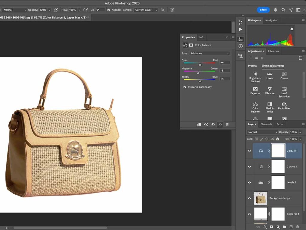 A handbag displayed in Adobe Photoshop, with instructions for filling an area in black using keyboard shortcuts.