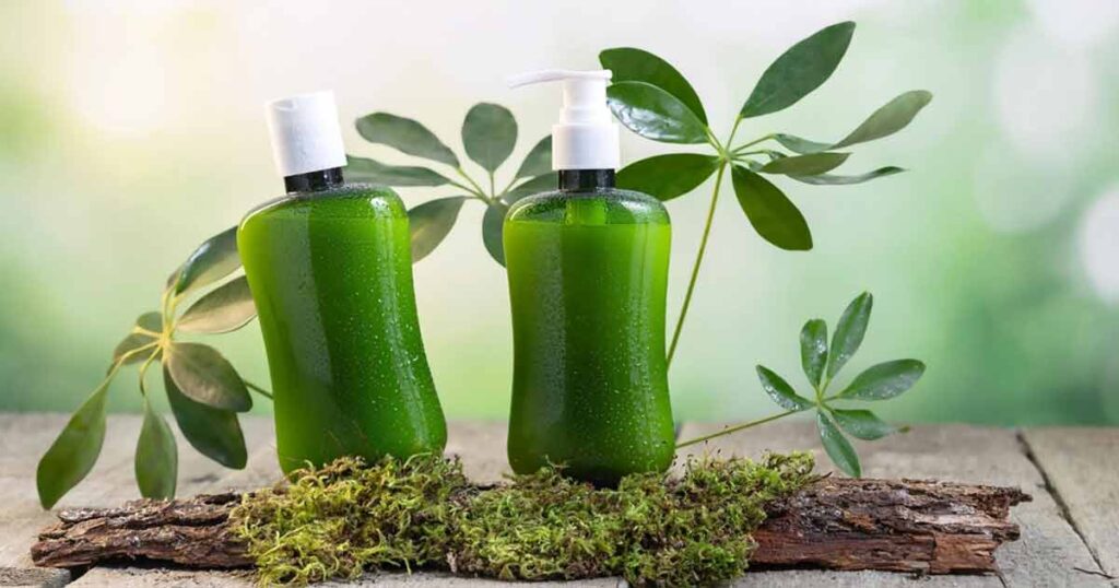 Two bottles of green liquid on a wooden table, showcasing outdoor image retouching techniques.