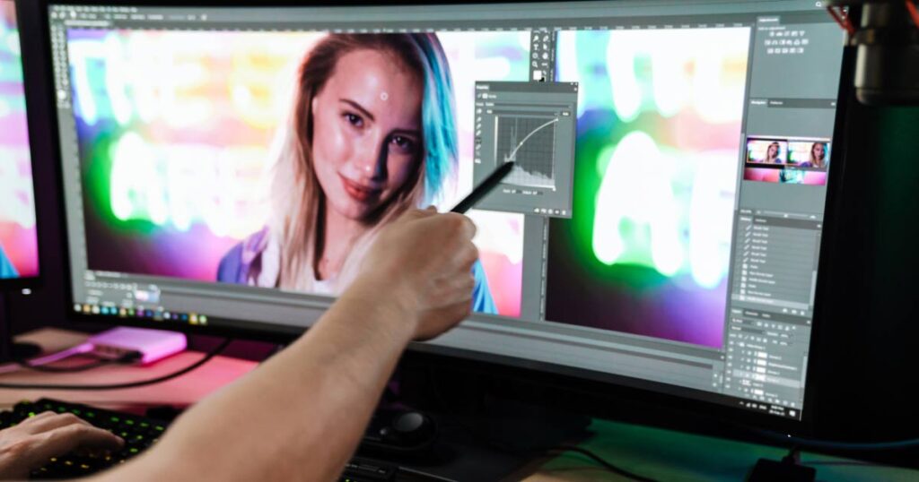 A person editing a photo on a computer, focusing on tone and color adjustments for enhancement.