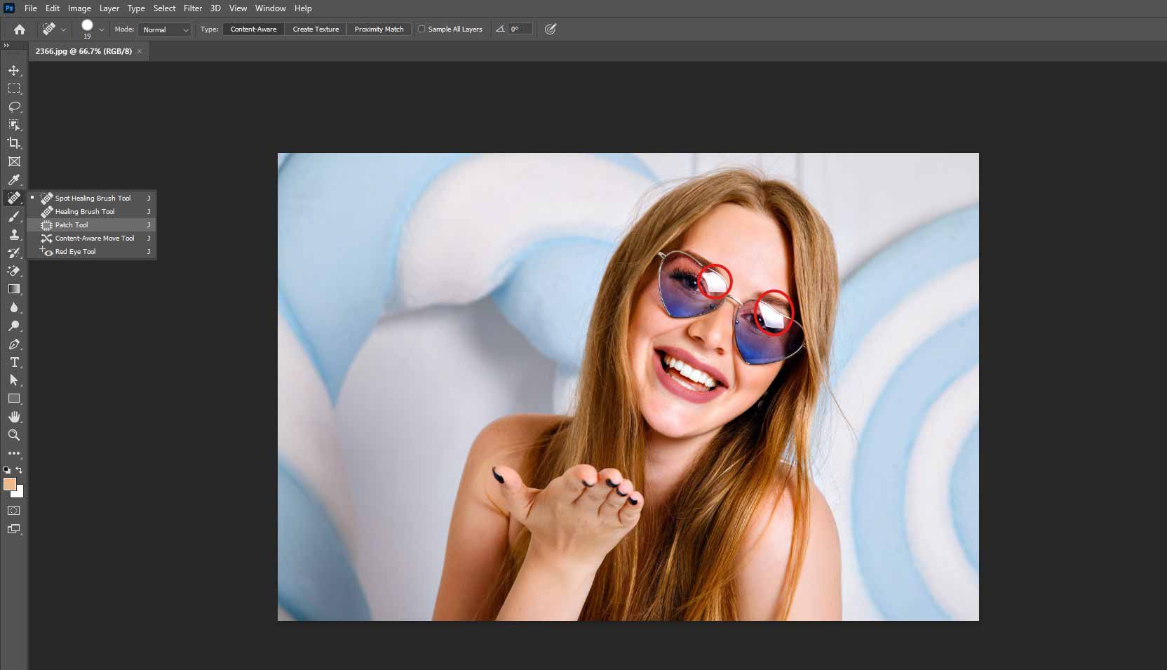 Select the glare area using the patch tool